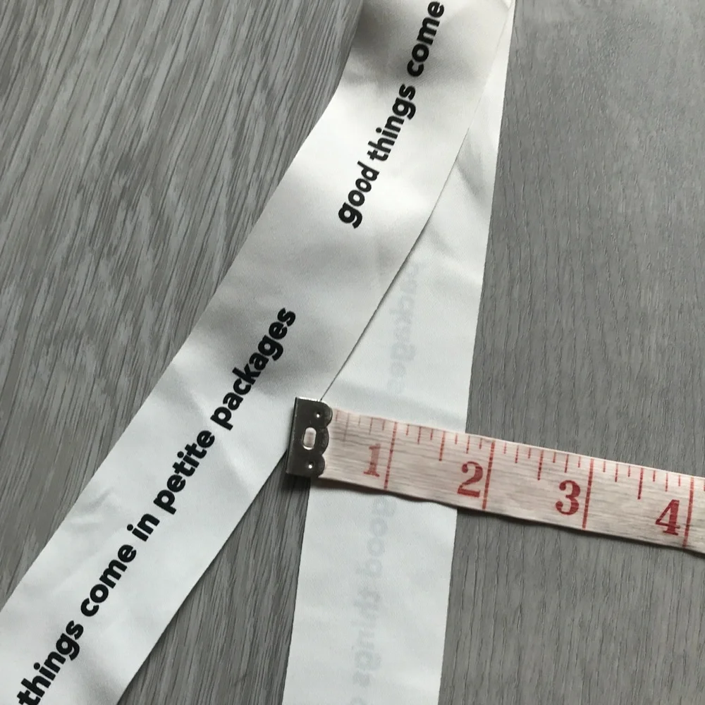 White Decorative Ribbon with Black Text - 'good things come in petite packages'